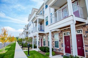 Skillman townhouse for rent - a row of townhomes with red doors and balconies