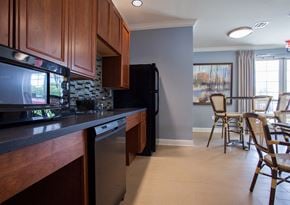 Perth Amboy apartment for rent - a kitchen and dining room with a table and chairs and a refrigerator