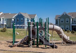 Willow Street apartment for rent - a playground with a slide and a tube in front of houses