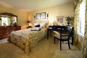 Glen Burnie apartment for rent - A bedroom with a bed, desk, and chair.