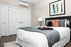 Washington apartment for rent - a bedroom with a bed and a white closet