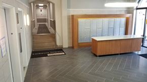 Washington apartment for rent - the lobby of a building with a locker room and stairs
