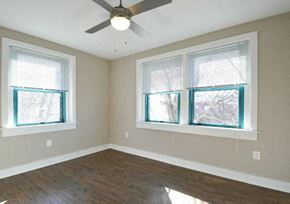 Washington apartment for rent - an empty room with a ceiling fan and three windows