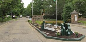 Dover apartment for rent - a sign for the entrance to experience village on the side of a road