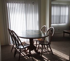 Dover apartment for rent - our dining room table in the sun shining through the blinds