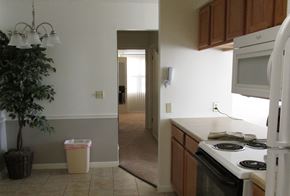 Dover apartment for rent - an empty kitchen with a stove and a door to a hallway