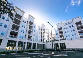 Orlando apartment for rent - a group of white apartment buildings with parking spaces
