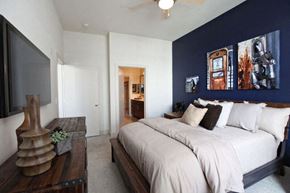 Houston apartment for rent - a blue and white bedroom with a large bed
