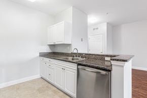 Hanover apartment for rent - a kitchen with white cabinets and granite counter tops and a stainless steel dishwasher