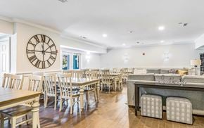 Hanover apartment for rent - a dining room with tables and chairs and a clock on the wall