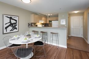 Langley apartment for rent - A modern dining room with a white table and chairs.