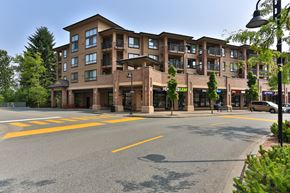 Langley apartment for rent - A large apartment building with a parking lot in front.