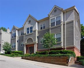 Cincinnati apartment for rent - A grey two story house with a brown door and windows.