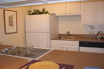 Cincinnati apartment for rent - A kitchen with a white refrigerator and brown countertops.