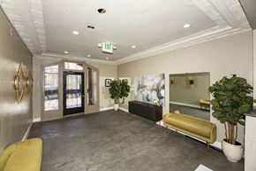 San Francisco apartment for rent - A well-lit waiting room with a yellow sofa and a large painting on the wall.