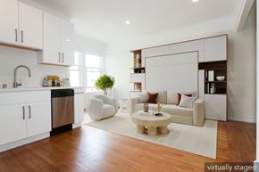 San Francisco apartment for rent - A modern kitchen with white cabinets and a wooden floor.