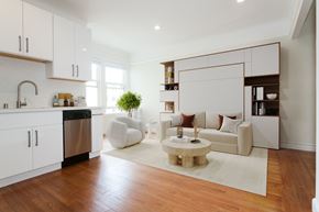 San Francisco apartment for rent - A modern kitchen with white cabinets and a wooden floor.