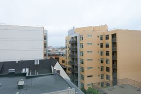 San Francisco apartment for rent - A view of a cityscape with buildings of different heights and a cloudy sky.