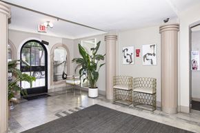 San Francisco apartment for rent - A white chair with a gold frame is in the middle of a room.