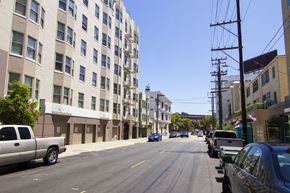 San Francisco apartment for rent - A street view of a residential area with cars parked on the side of the road.