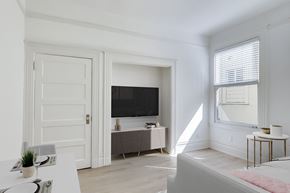 San Francisco apartment for rent - A white room with a television and a bed.