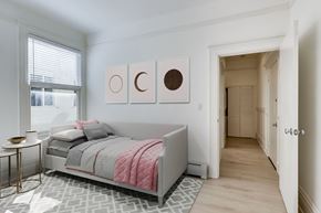 San Francisco apartment for rent - A bedroom with a bed, a nightstand, and a painting on the wall.