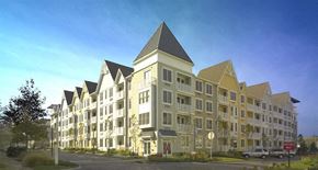 Long Branch apartment for rent - A large, modern apartment building with a mix of beige and white exterior colors.