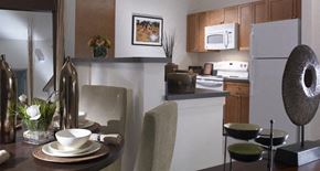 Long Branch apartment for rent - A modern kitchen with a dining table set for two.