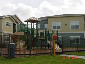 Houston apartment for rent - a playground in a yard in front of a house