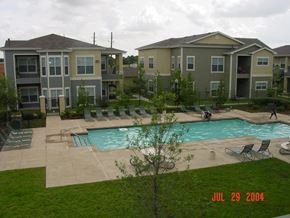 Houston apartment for rent - an aerial view of an apartment complex with a swimming pool
