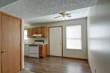 Morgantown apartment for rent - a kitchen with a white stove and a ceiling fan