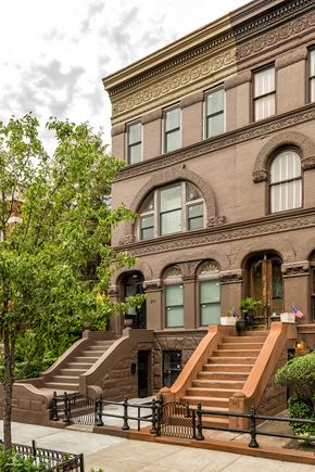 Brooklyn apartment for rent - A brown building with a black fence in front.