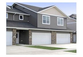 West Fargo townhouse for rent - a house with two garage doors in front of it