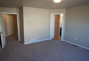 West Fargo townhouse for rent - an empty living room with a door to a bathroom