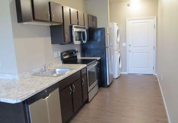 Moorhead apartment for rent - a kitchen with a stove refrigerator and a sink