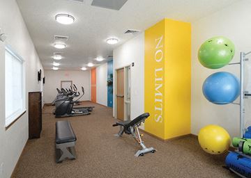 Des Moines apartment for rent - A gym with a yellow wall and a sign that says "NOUNS" on it.