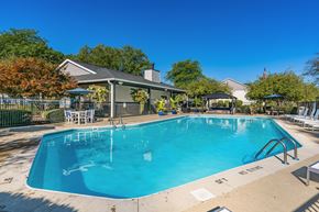 Lewis Center apartment for rent - A large outdoor swimming pool with a pavilion and lounge chairs.