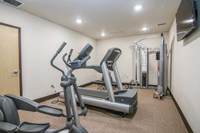 Cross Plains apartment for rent - a gym with a treadmill and weights in the corner of a room