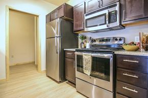 Cross Plains apartment for rent - a kitchen with stainless steel appliances and a refrigerator
