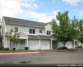 Hillsboro apartment for rent - A two-story house with a garage and a tree in front.