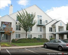 Hillsboro apartment for rent - A silver car is parked in front of a two-story building.