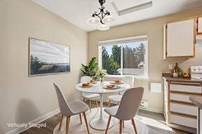 Hillsboro apartment for rent - A dining room with a table set for two and a painting of a landscape on the wall.