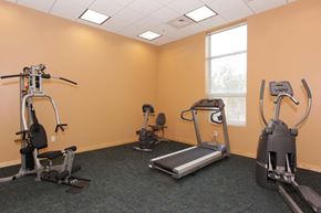 Pittsburgh apartment for rent - a gym with exercise equipment and a window
