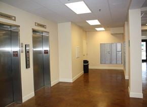 New Orleans apartment for rent - an empty hallway with elevators and doors in a building