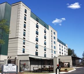 New Orleans apartment for rent - a large white building with a sign in front of it