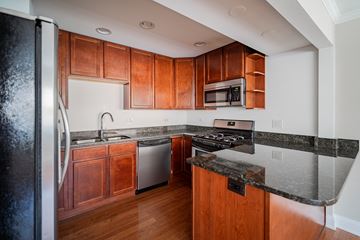 Evanston apartment for rent - a kitchen with wooden cabinets and granite counter tops and stainless steel appliances