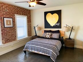 Los Angeles apartment for rent - a bedroom with a bed and a painting of a heart on the wall