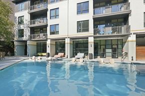 Atlanta apartment for rent - A large swimming pool in front of a modern apartment building.