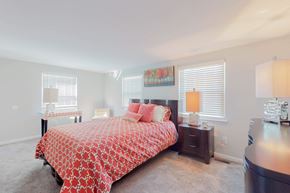 Glen Burnie townhouse for rent - a bedroom with a bed and two windows