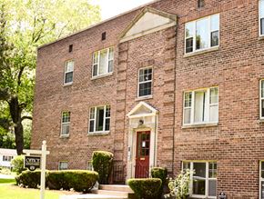 Rochester townhouse for rent - a brick building with a red door and a sign in front